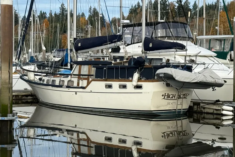  Yacht Photos Pics 1980 Nauticat Pilothouse sailboat docked in a marina, reflecting on calm water.