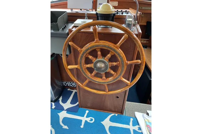  Yacht Photos Pics Wooden steering wheel of a 1980 Nauticat Pilothouse boat, with nautical decor.
