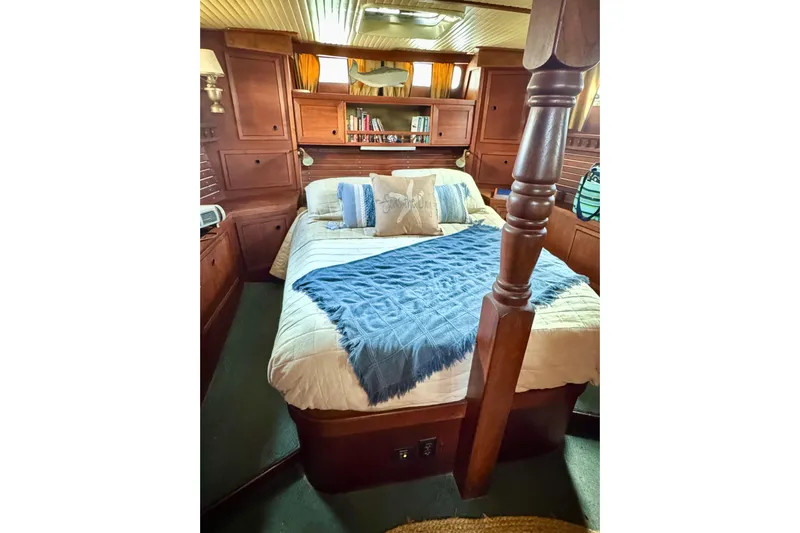  Yacht Photos Pics Cozy 1980 Nauticat Pilothouse bedroom with wooden interior and comfortable bedding.