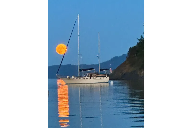  Yacht Photos Pics 1980 Nauticat Pilothouse sailboat on calm water with a full moon reflection.
