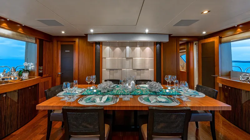 Emrys Yacht Photos Pics Luxurious dining area on 2010 Sunseeker Flybridge yacht, featuring elegant table settings and modern decor.