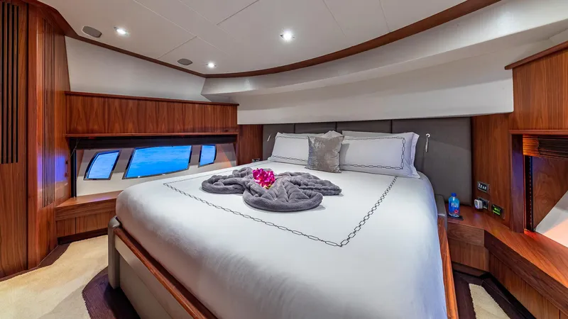 Emrys Yacht Photos Pics Luxurious Sunseeker Flybridge 2010 yacht bedroom with elegant wood finishes and ocean view windows.