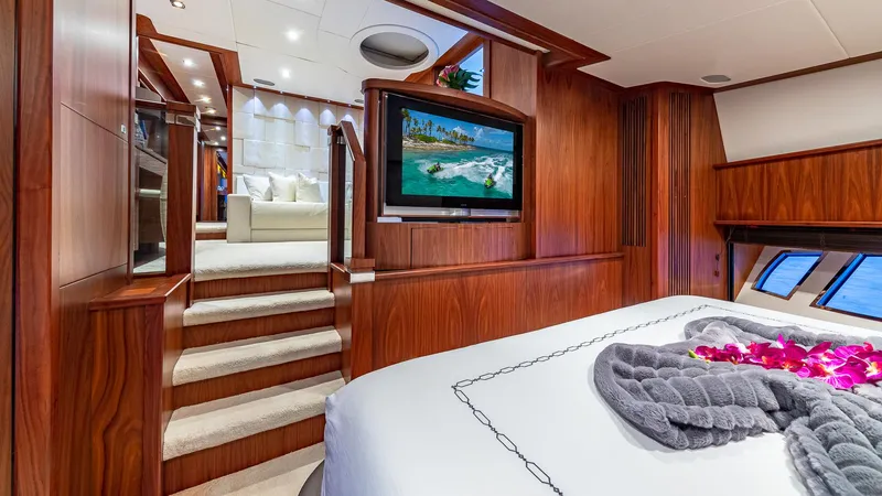 Emrys Yacht Photos Pics Luxurious Sunseeker Flybridge 2010 yacht interior with elegant wood paneling and cozy bedroom.