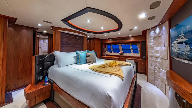 Emrys Yacht Photos Pics Luxurious Sunseeker Flybridge 2010 yacht bedroom with elegant wood finishes and modern lighting.
