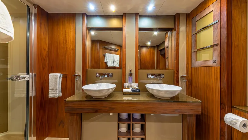 Emrys Yacht Photos Pics Luxurious Sunseeker Flybridge 2010 yacht bathroom with dual sinks and elegant wood finish.