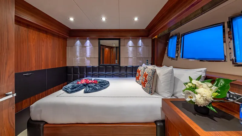 Emrys Yacht Photos Pics Luxurious Sunseeker Flybridge 2010 yacht bedroom with elegant decor and ocean view windows.