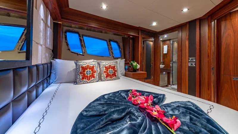 Emrys Yacht Photos Pics Luxurious Sunseeker Flybridge 2010 yacht bedroom with elegant decor and floral accents.