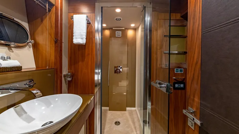 Emrys Yacht Photos Pics Luxurious bathroom interior of 2010 Sunseeker Flybridge yacht with modern fixtures and wood accents.
