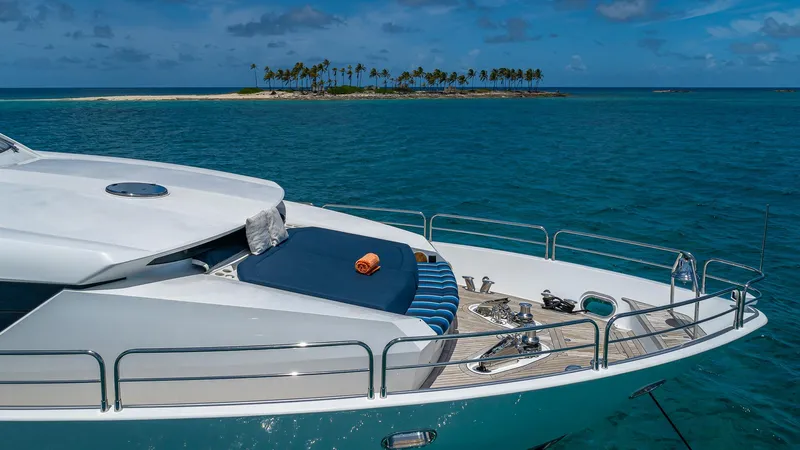 Emrys Yacht Photos Pics Sunseeker Flybridge 2010 yacht anchored near tropical island, clear blue ocean, sunny day.