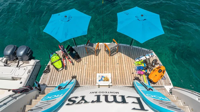 Emrys Yacht Photos Pics Sunseeker Flybridge 2010 yacht deck with water sports gear and blue umbrellas.