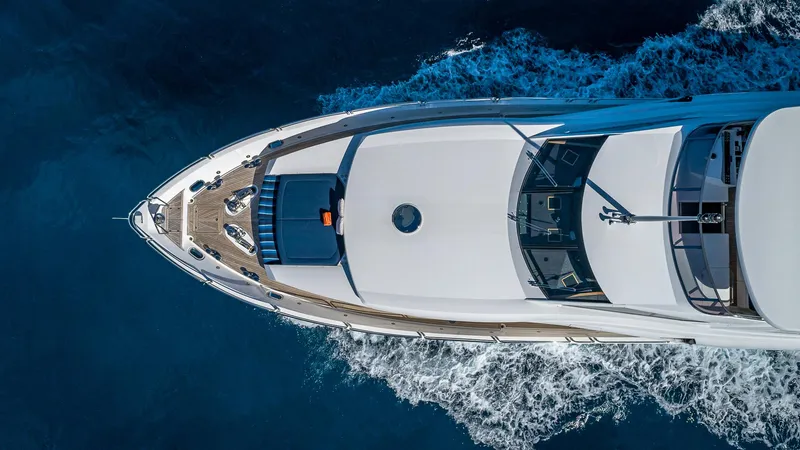 Emrys Yacht Photos Pics Aerial view of 2010 Sunseeker Flybridge yacht cruising on blue ocean waters.
