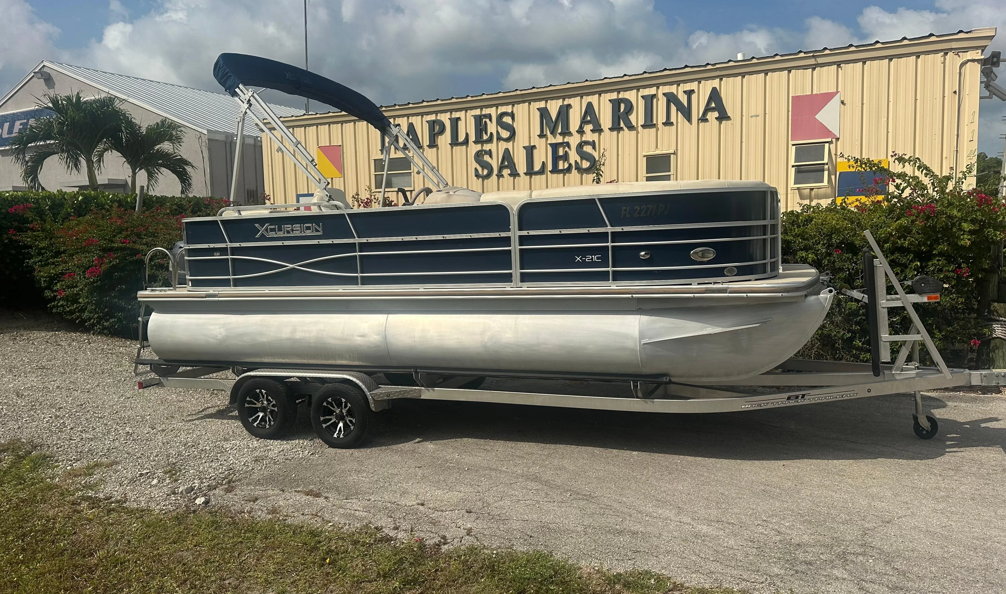 2012 Xcursion X21C pontoon boat on trailer at Naples Marina Sales.
