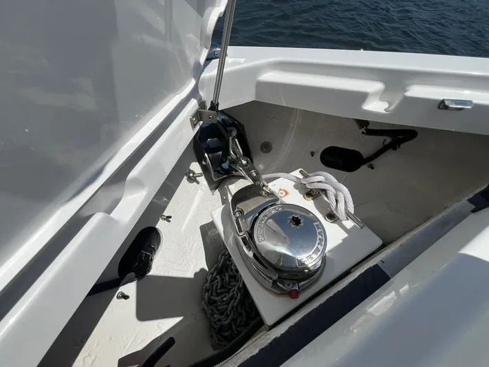  Yacht Photos Pics 2022 Cobalt R8 Outboard anchor compartment with chain and rope on a sunny day.