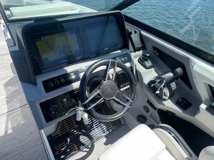  Yacht Photos Pics 2022 Cobalt R8 Outboard boat dashboard with steering wheel and navigation screens.