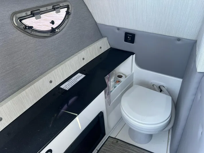  Yacht Photos Pics 2022 Cobalt R8 Outboard boat interior with compact bathroom and modern amenities.