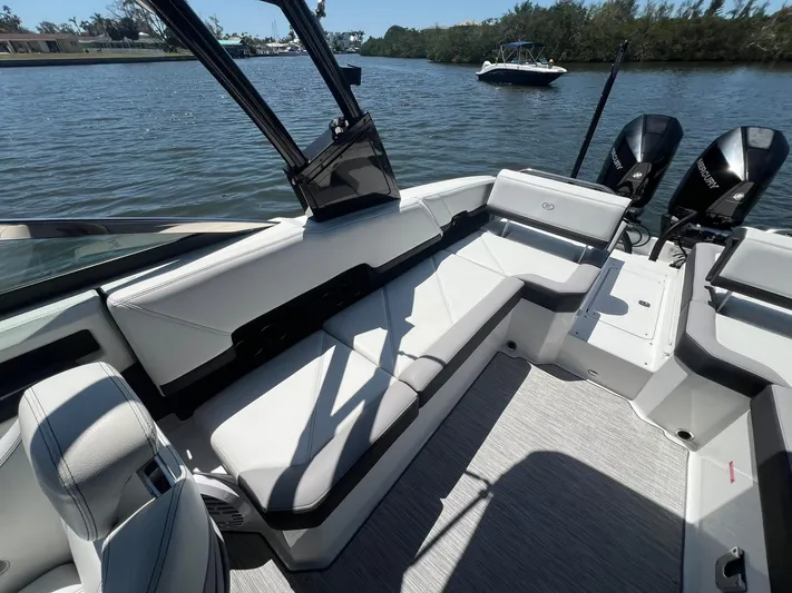  Yacht Photos Pics 2022 Cobalt R8 Outboard boat interior with sleek seating, on a calm waterway.