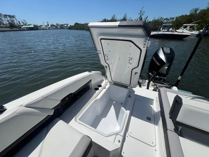  Yacht Photos Pics 2022 Cobalt R8 Outboard boat with open storage compartment on a calm lake.