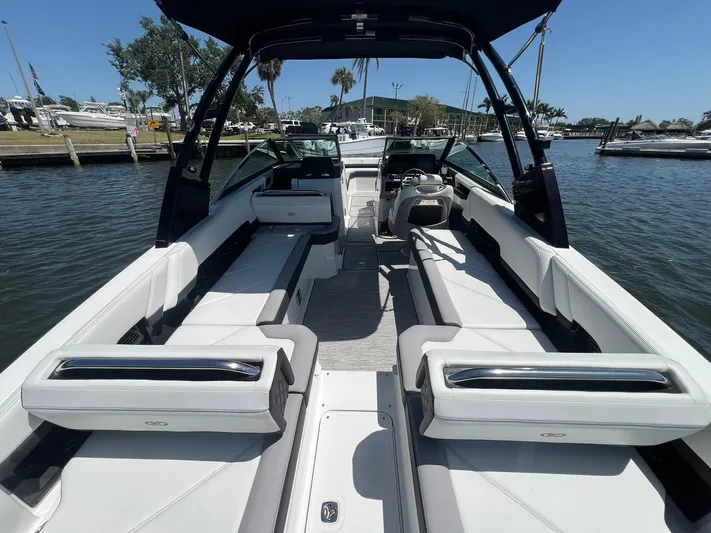  Yacht Photos Pics 2022 Cobalt R8 Outboard boat interior with sleek seating and modern design on a sunny day.