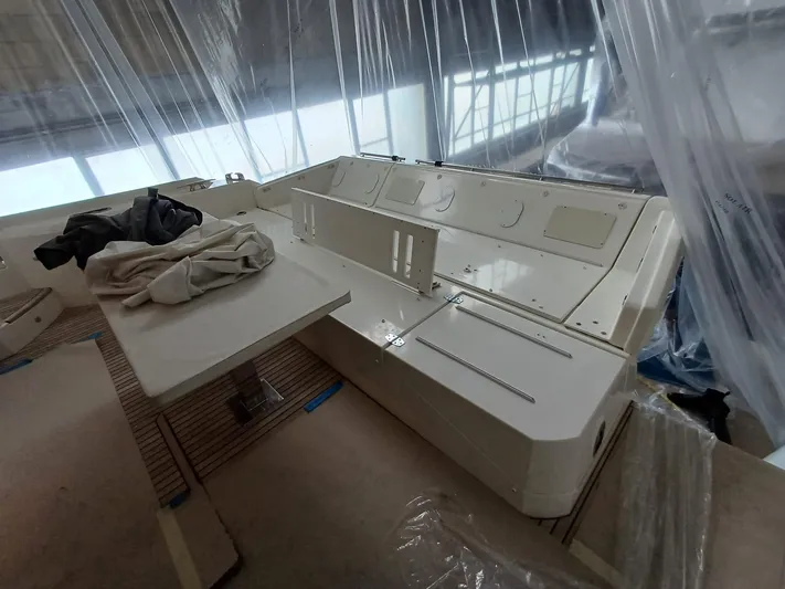  Yacht Photos Pics Luxury yacht interior under construction, Prestige 590, 2020 model, with covered seating and table.