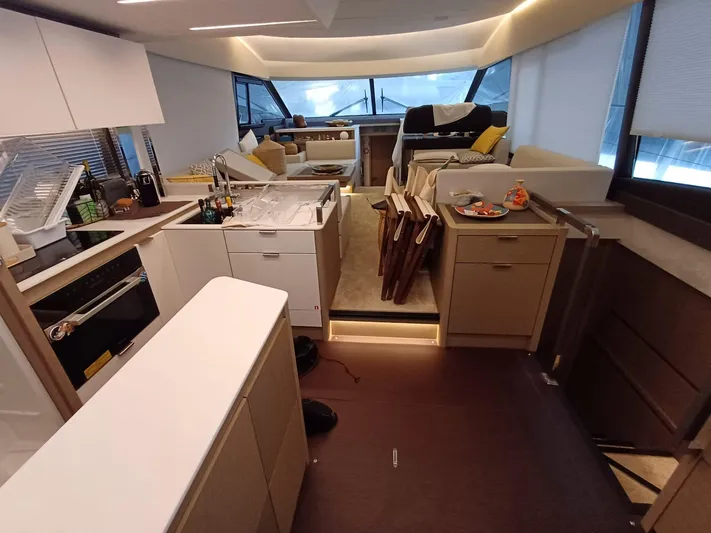  Yacht Photos Pics Luxurious interior of a 2020 Prestige 590 yacht with modern kitchen and seating area.