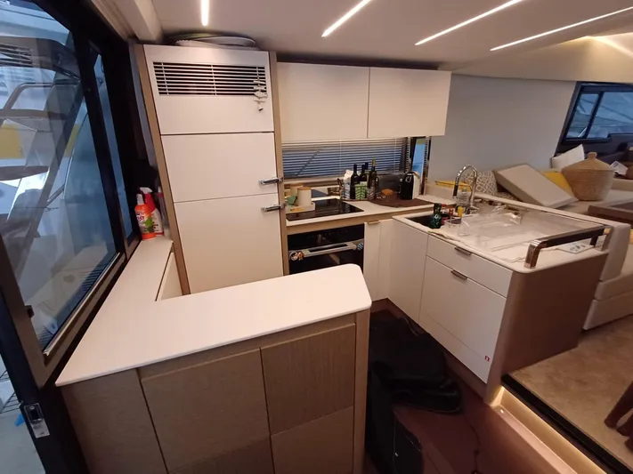  Yacht Photos Pics Modern kitchen interior on a 2020 Prestige 590 yacht, featuring sleek cabinetry and appliances.