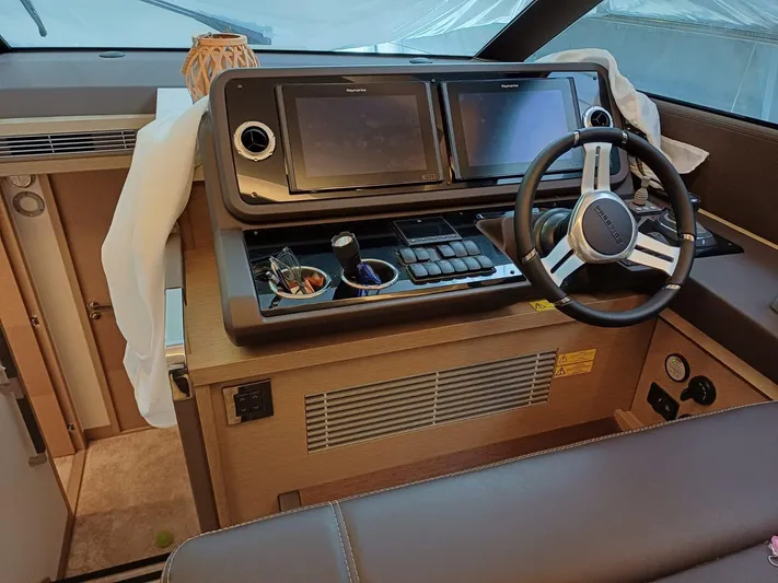  Yacht Photos Pics Helm of 2020 Prestige 590 yacht with dual navigation screens and steering wheel.