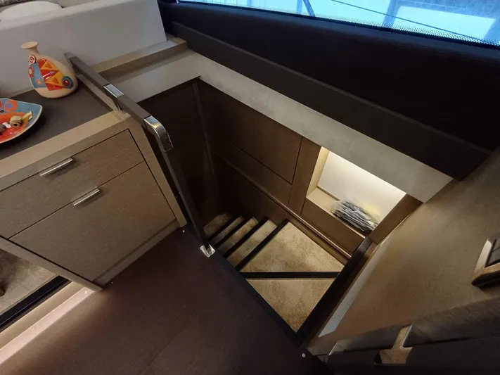  Yacht Photos Pics Staircase leading below deck on a 2020 Prestige 590 yacht interior.