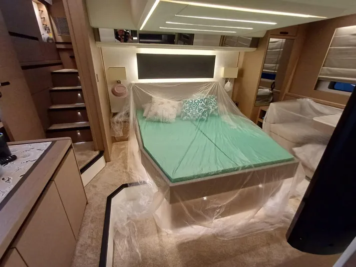  Yacht Photos Pics Luxurious interior of a 2020 Prestige 590 yacht with a neatly arranged bed.