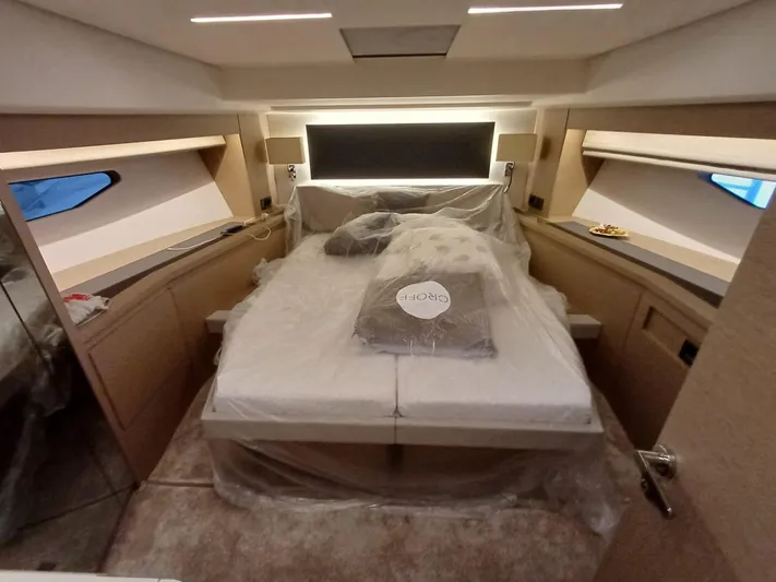  Yacht Photos Pics Luxurious cabin interior of a 2020 Prestige 590 yacht with a neatly made bed.
