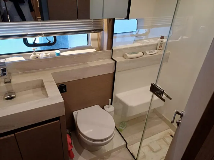  Yacht Photos Pics Luxurious bathroom in 2020 Prestige 590 yacht with modern fixtures and glass shower.