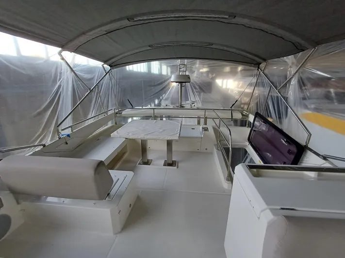  Yacht Photos Pics 2020 Prestige 590 yacht interior with covered seating and dining area.