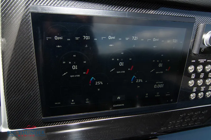  Yacht Photos Pics 2023 Fountain 38 SC dashboard with Garmin display and carbon fiber trim.