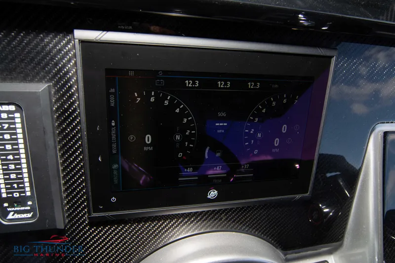  Yacht Photos Pics Dashboard of a 2023 Fountain 38 SC boat with digital display and carbon fiber finish.