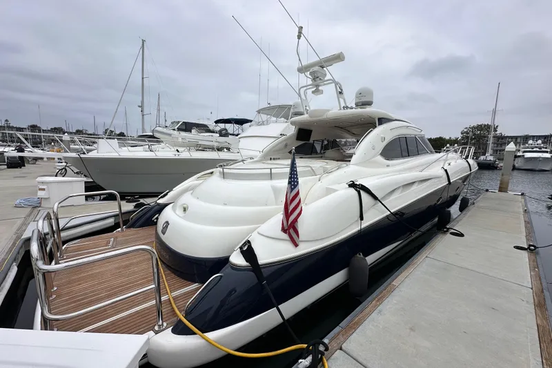 D Yacht Photos Pics Luxury Sunseeker Predator 60 yacht docked at marina, 2000 model, with American flag.
