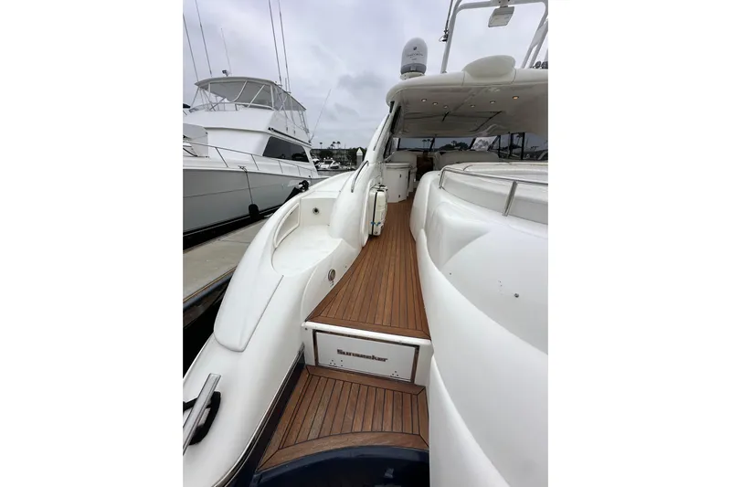 D Yacht Photos Pics Sunseeker Predator 60 yacht, 2000 model, featuring sleek white design and wooden deck.