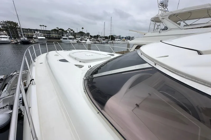 D Yacht Photos Pics Sunseeker Predator 60 yacht, 2000 model, docked in a marina with overcast skies.