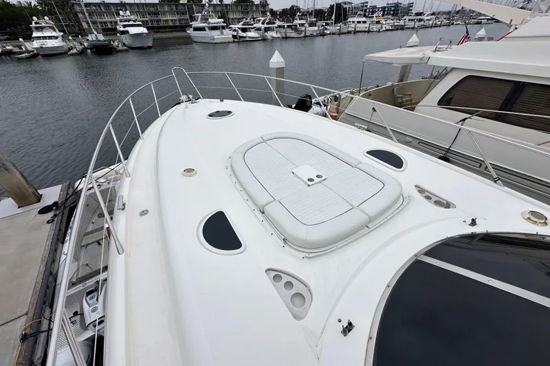 D Yacht Photos Pics Sunseeker Predator 60 yacht, 2000 model, docked in a marina with other boats.