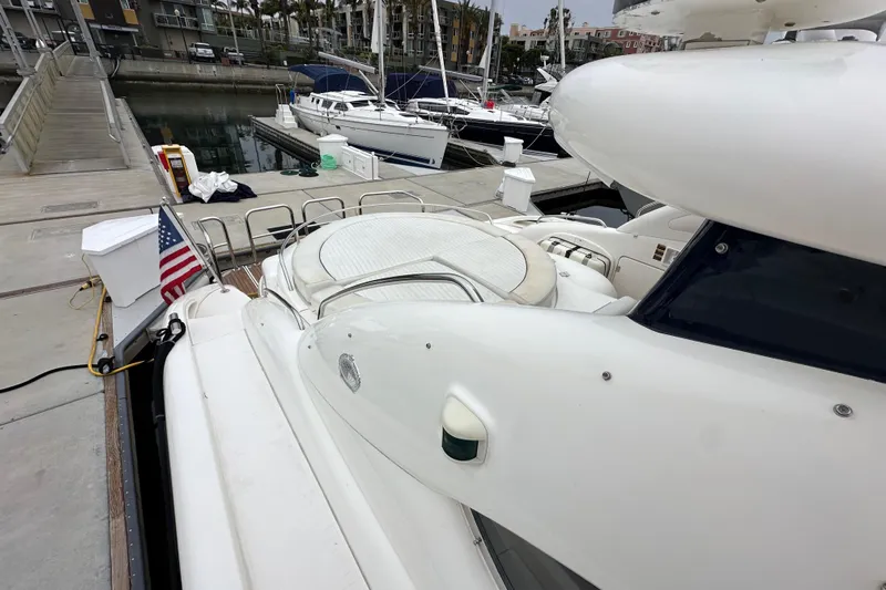 D Yacht Photos Pics Sunseeker Predator 60 yacht docked at marina, rear view, American flag displayed.