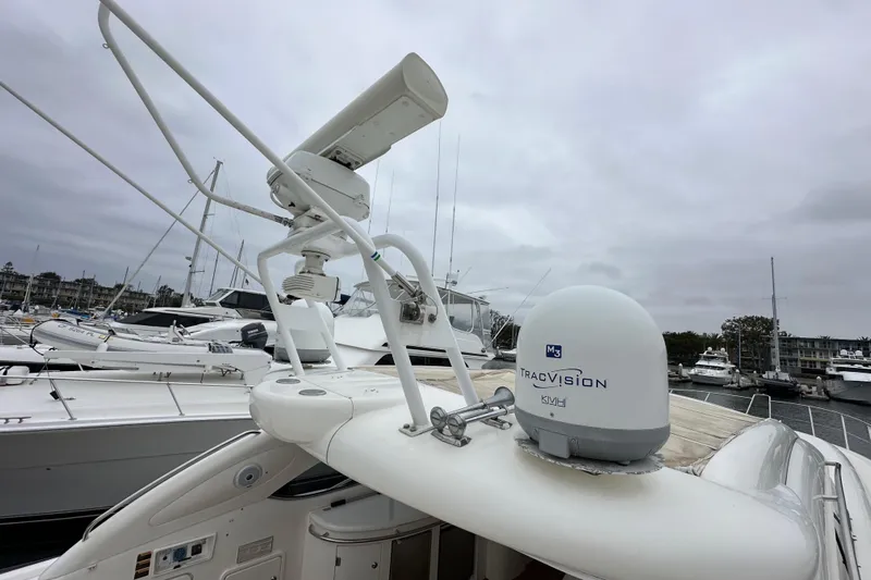D Yacht Photos Pics Sunseeker Predator 60 yacht, 2000 model, featuring TracVision satellite system in a marina setting.