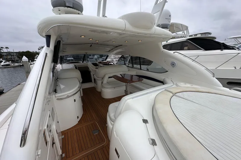 D Yacht Photos Pics Luxurious 2000 Sunseeker Predator 60 yacht interior with sleek white seating and wooden flooring.