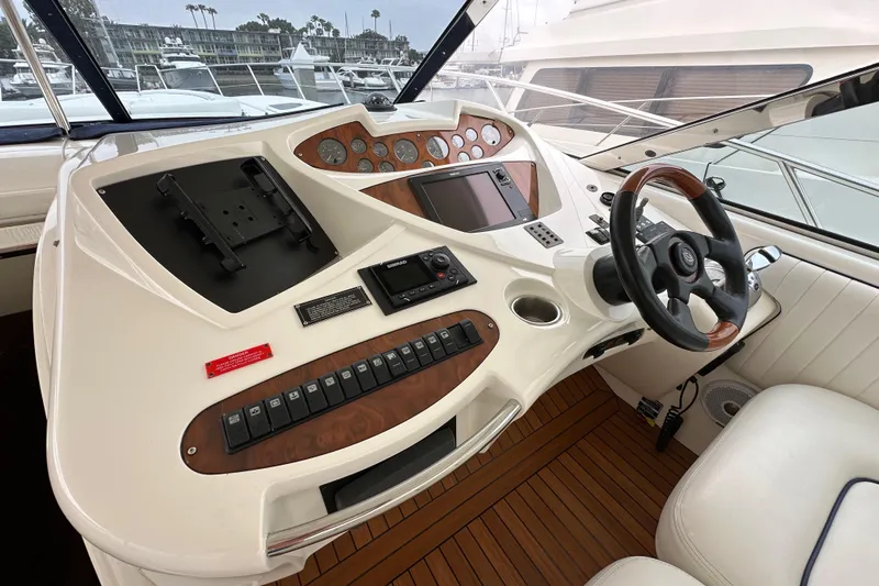 D Yacht Photos Pics Cockpit of 2000 Sunseeker Predator 60 yacht with steering wheel and control panel.
