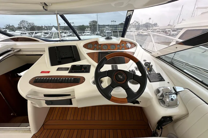 D Yacht Photos Pics Cockpit of 2000 Sunseeker Predator 60 yacht with steering wheel and control panel.