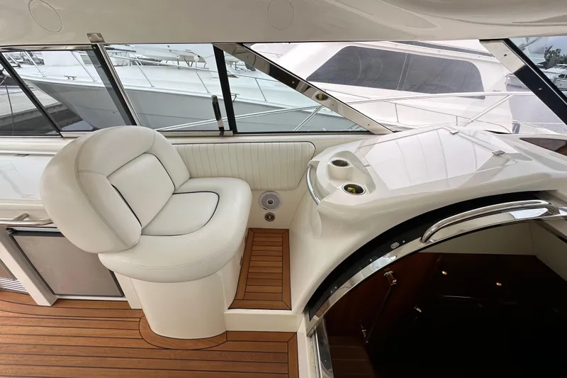 D Yacht Photos Pics Luxurious interior of 2000 Sunseeker Predator 60 yacht with white seating and wooden flooring.
