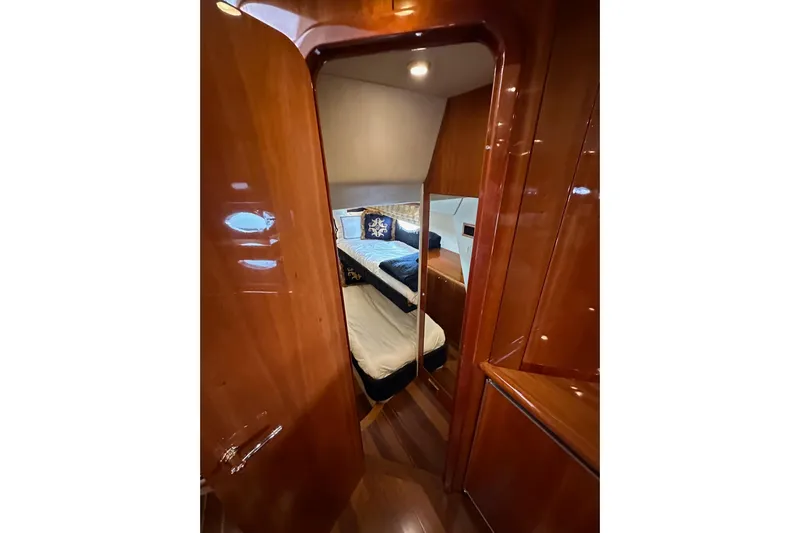 D Yacht Photos Pics Luxurious cabin interior of 2000 Sunseeker Predator 60 yacht with polished wood finish.