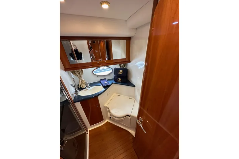 D Yacht Photos Pics Luxurious bathroom in 2000 Sunseeker Predator 60 yacht with wood accents and modern fixtures.