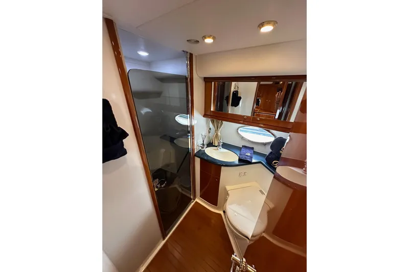 D Yacht Photos Pics Luxurious bathroom in 2000 Sunseeker Predator 60 yacht with modern fixtures and wood accents.