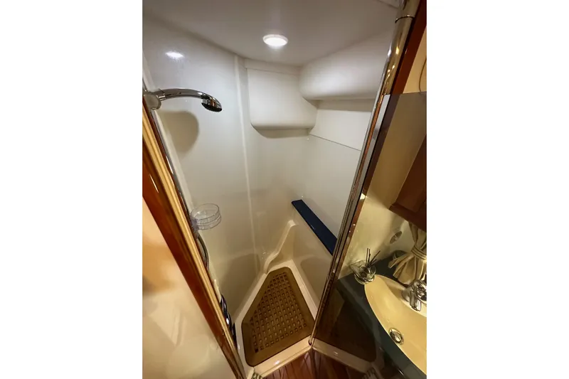 D Yacht Photos Pics Shower area in 2000 Sunseeker Predator 60 yacht, featuring modern fixtures and wooden accents.