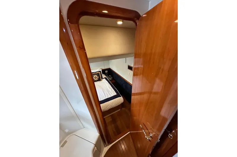 D Yacht Photos Pics Interior cabin of 2000 Sunseeker Predator 60 yacht with wooden door and cozy bed.