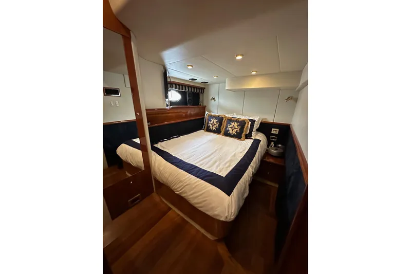 D Yacht Photos Pics Luxurious cabin interior of 2000 Sunseeker Predator 60 yacht with elegant bedding.