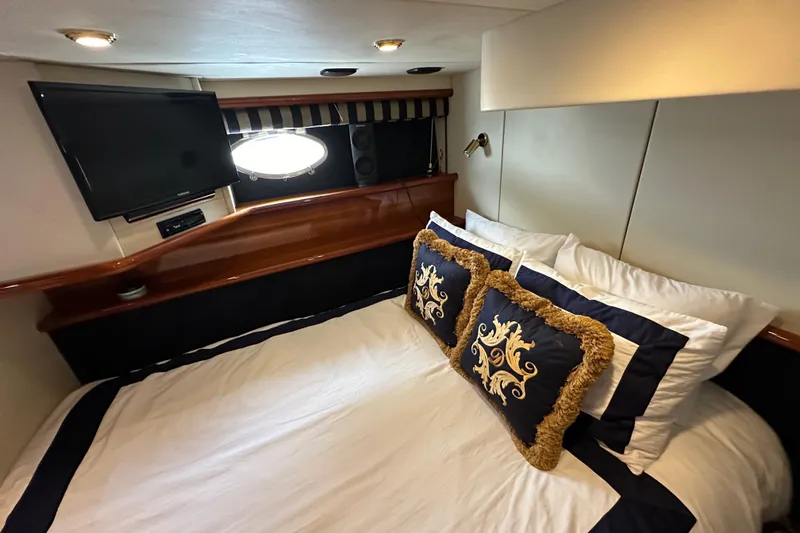 D Yacht Photos Pics Luxurious cabin interior of 2000 Sunseeker Predator 60 yacht with elegant bedding and TV.